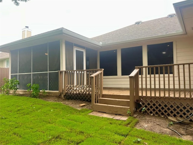 612 Thrush Dr, Leander, TX 78641 - rear view of property featuring a sunroom, a wooden deck, roof with shingles, a chimney, and a lawn
