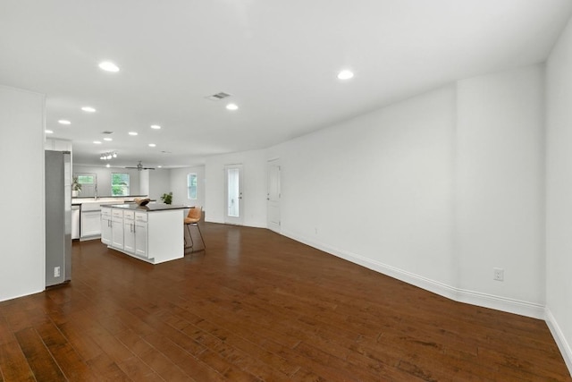 1612 Westmoor Dr, Austin, TX 78723 - unfurnished living room featuring recessed lighting and dark wood-type flooring