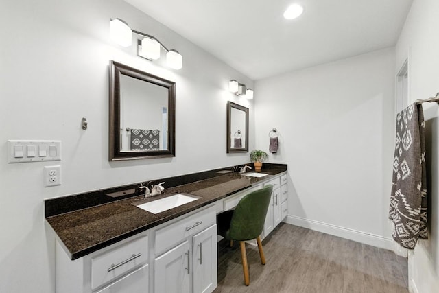 1612 Westmoor Dr, Austin, TX 78723 - bathroom featuring double vanity, wood finished floors, and recessed lighting