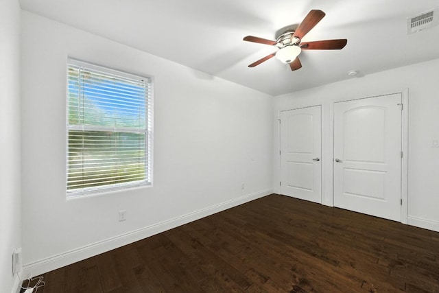 1612 Westmoor Dr, Austin, TX 78723 - unfurnished bedroom with dark wood-type flooring and a ceiling fan