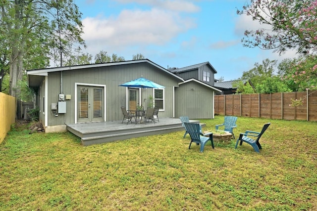 1612 Westmoor Dr, Austin, TX 78723 - back of property with a wooden deck, a fenced backyard, a fire pit, and french doors