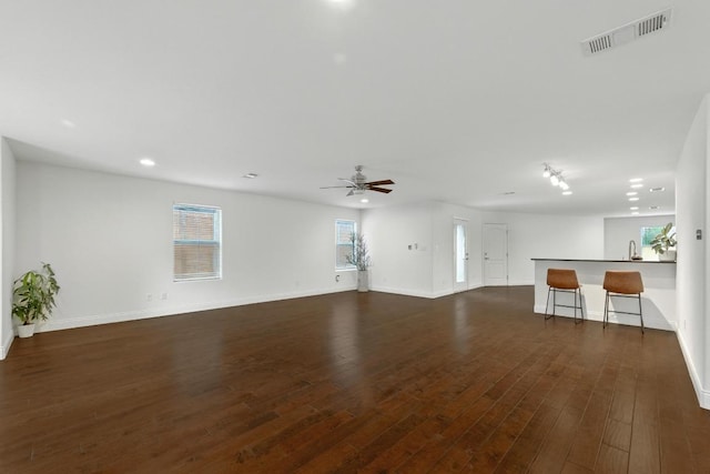 1612 Westmoor Dr, Austin, TX 78723 - unfurnished living room with a ceiling fan, dark wood finished floors, and recessed lighting