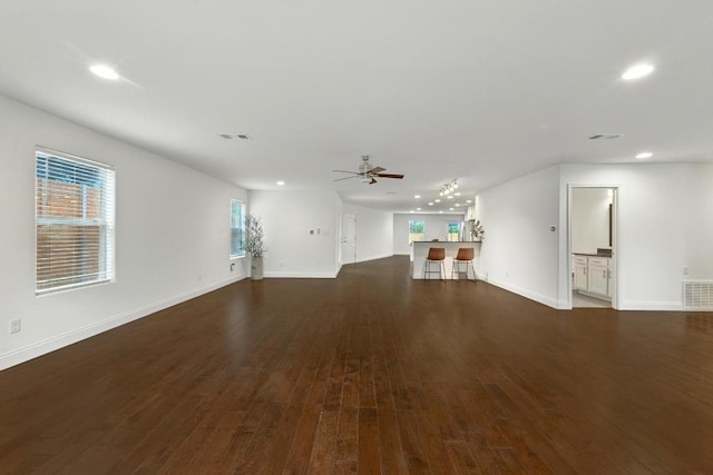 1612 Westmoor Dr, Austin, TX 78723 - unfurnished living room with ceiling fan, recessed lighting, and dark wood-type flooring