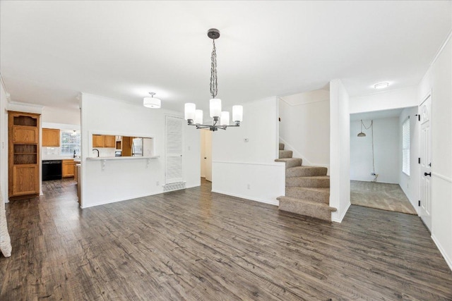 8516 Rockwood Ln, Austin, TX 78757 - unfurnished living room with a chandelier, dark wood-style floors, and stairs