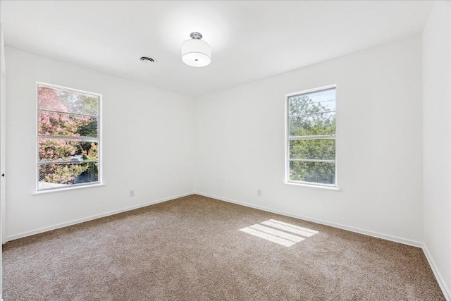 8516 Rockwood Ln, Austin, TX 78757 - spare room featuring carpet flooring and baseboards