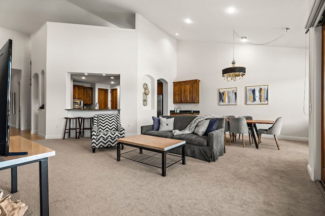 427 Marina Village Cv Unit 427, Austin, TX 78734 - living room featuring light colored carpet, arched walkways, recessed lighting, high vaulted ceiling, and a chandelier