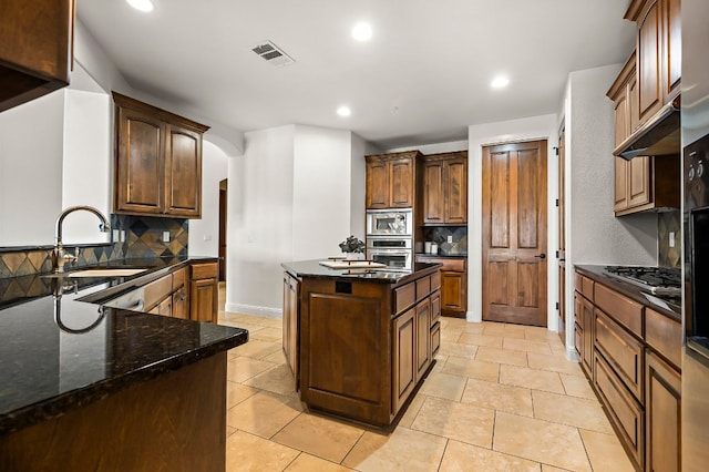 427 Marina Village Cv Unit 427, Austin, TX 78734 - kitchen with appliances with stainless steel finishes, backsplash, arched walkways, under cabinet range hood, and recessed lighting
