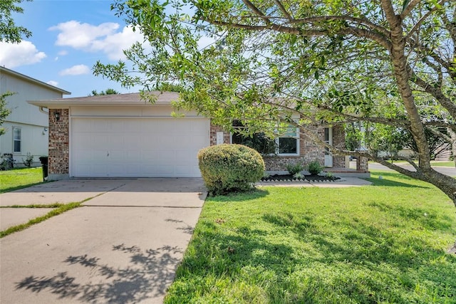 100 Grant Cv, Hutto, TX 78634 - view of front of house featuring concrete driveway, a front lawn, an attached garage, and brick siding