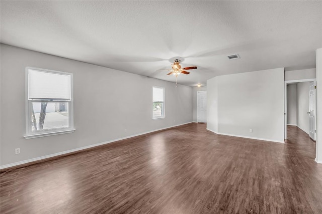 100 Grant Cv, Hutto, TX 78634 - empty room with ceiling fan, dark wood finished floors, and a textured ceiling