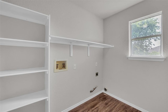 100 Grant Cv, Hutto, TX 78634 - washroom with electric dryer hookup, dark wood finished floors, gas dryer hookup, and hookup for a washing machine