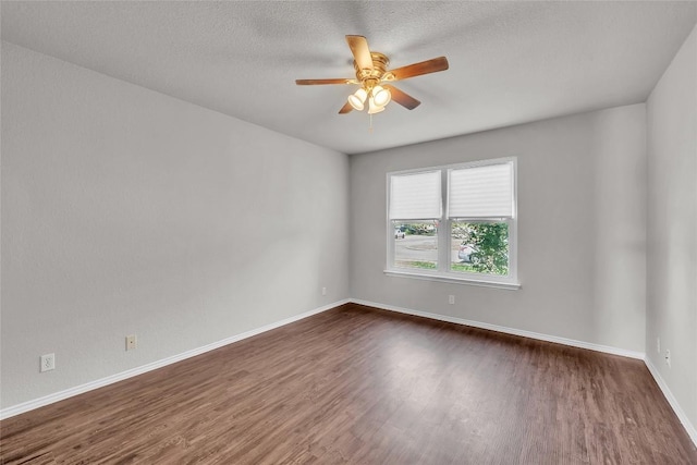 100 Grant Cv, Hutto, TX 78634 - empty room with dark wood-style floors, ceiling fan, and a textured ceiling