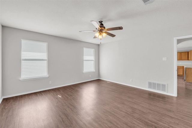 100 Grant Cv, Hutto, TX 78634 - unfurnished room featuring ceiling fan, dark wood-style floors, and arched walkways