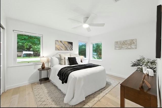 4508 Chiappero Trl, Austin, TX 78731 - bedroom featuring multiple windows, light wood-style flooring, and ceiling fan