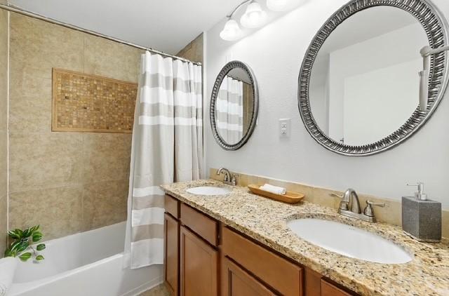 4508 Chiappero Trl, Austin, TX 78731 - full bathroom with double vanity and shower / tub combo with curtain