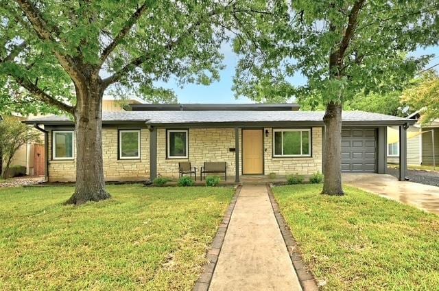 4508 Chiappero Trl, Austin, TX 78731 - ranch-style home featuring a garage, a front lawn, driveway, and stone siding
