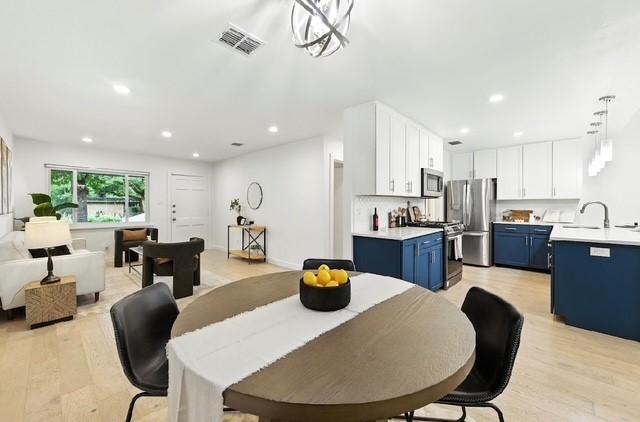 4508 Chiappero Trl, Austin, TX 78731 - dining room with light wood-style flooring and recessed lighting