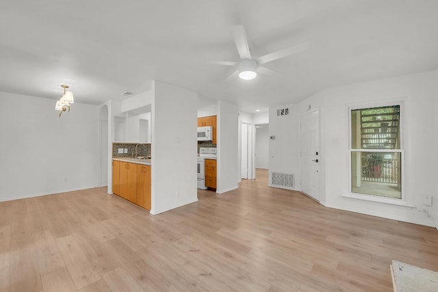 10616 Mellow Mdws Unit 17A, Austin, TX 78750 - unfurnished living room with light wood-style flooring and a ceiling fan
