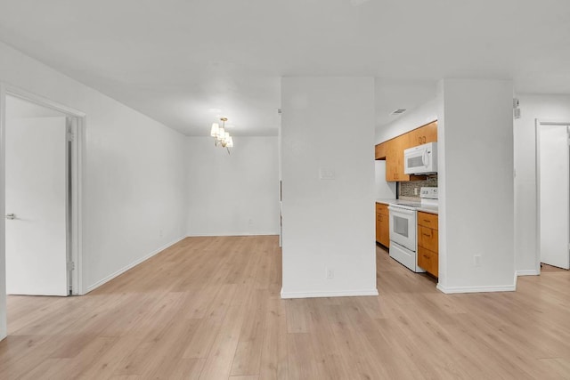 10616 Mellow Mdws Unit 17A, Austin, TX 78750 - unfurnished living room featuring light wood-style flooring and a chandelier