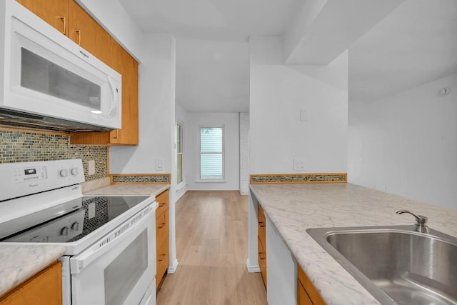 10616 Mellow Mdws Unit 17A, Austin, TX 78750 - kitchen with white appliances, light wood-style floors, decorative backsplash, and brown cabinetry