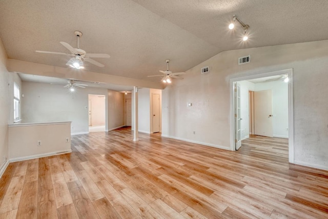 4901 Transit Cir, Austin, TX 78727 - unfurnished room featuring ceiling fan, vaulted ceiling, light wood-style floors, and a textured ceiling