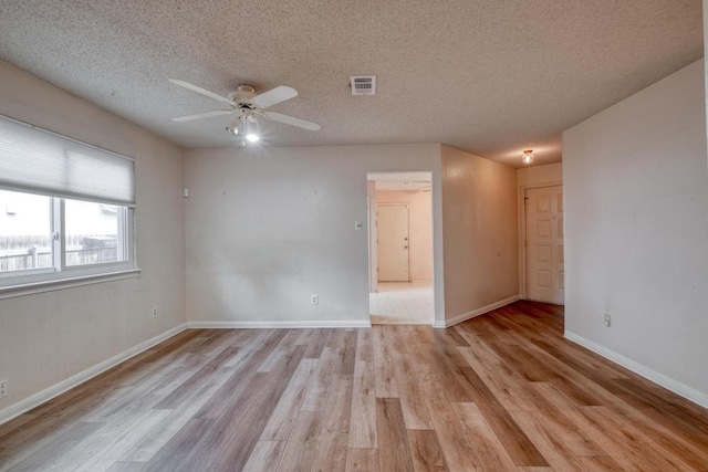 4901 Transit Cir, Austin, TX 78727 - spare room featuring a ceiling fan, light wood finished floors, and a textured ceiling