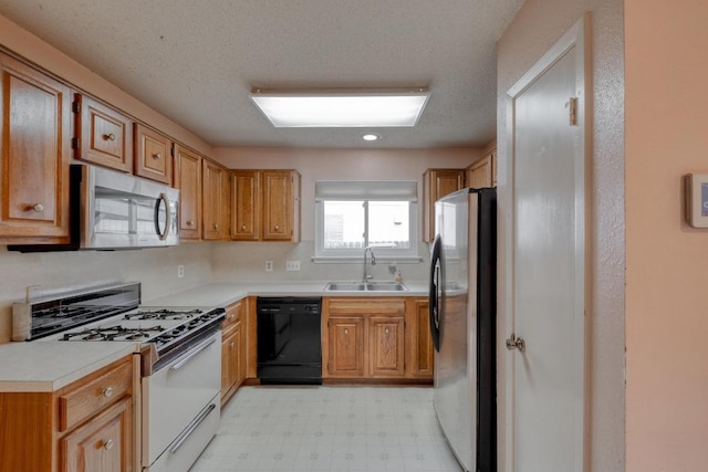 4901 Transit Cir, Austin, TX 78727 - kitchen with stainless steel appliances, light flooring, light countertops, and brown cabinetry