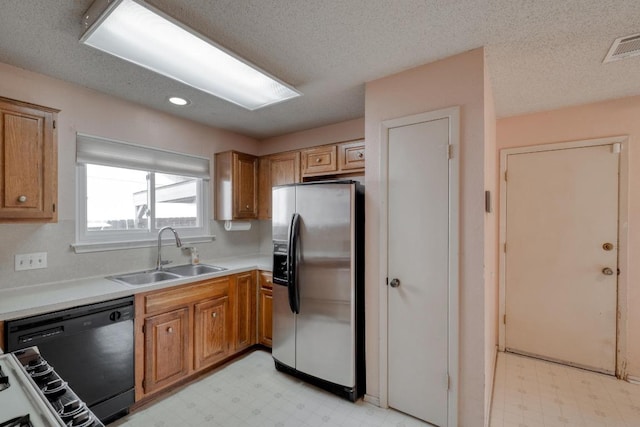 4901 Transit Cir, Austin, TX 78727 - kitchen featuring stainless steel fridge, dishwasher, light flooring, brown cabinetry, and light countertops
