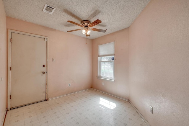 4901 Transit Cir, Austin, TX 78727 - unfurnished room featuring tile patterned floors, ceiling fan, and a textured ceiling