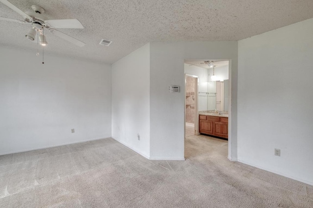 4901 Transit Cir, Austin, TX 78727 - empty room with light colored carpet, a ceiling fan, and a textured ceiling