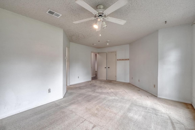 4901 Transit Cir, Austin, TX 78727 - unfurnished bedroom with light colored carpet, a textured ceiling, and ceiling fan