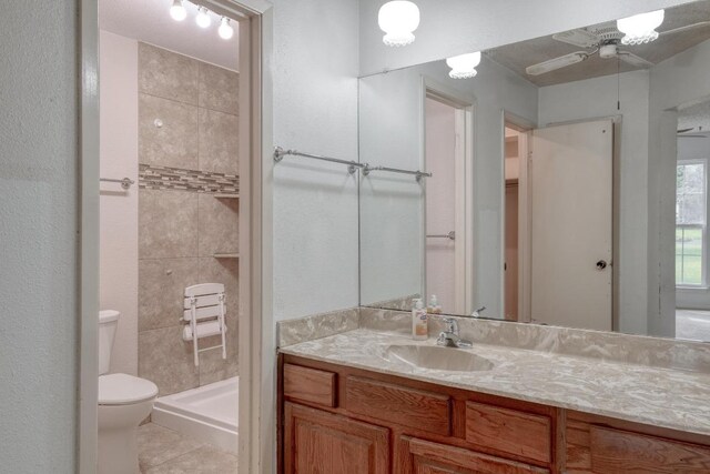 4901 Transit Cir, Austin, TX 78727 - bathroom featuring vanity, tiled shower, tile patterned flooring, and ceiling fan