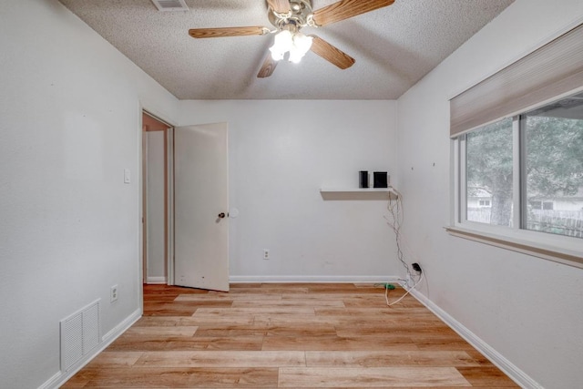 4901 Transit Cir, Austin, TX 78727 - empty room with a textured ceiling, ceiling fan, and light wood-style floors
