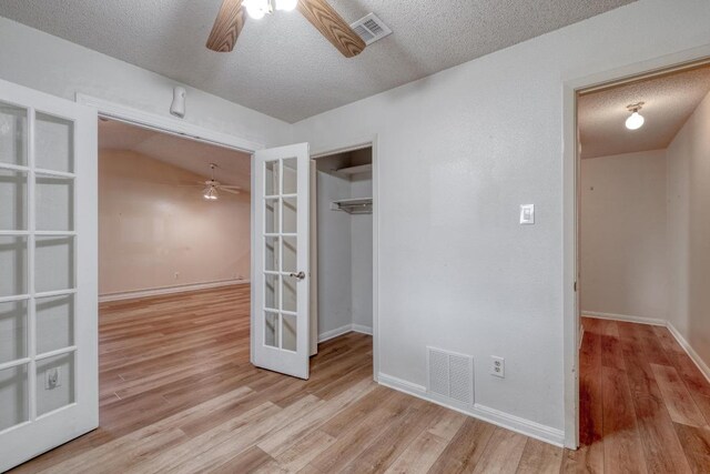 4901 Transit Cir, Austin, TX 78727 - spare room with a ceiling fan, french doors, a textured ceiling, and wood finished floors