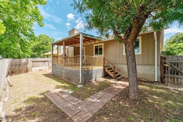4901 Transit Cir, Austin, TX 78727 - back of house with a fenced backyard, a wooden deck, and a chimney