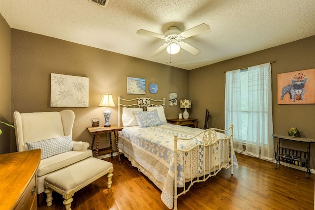 3508 Wendel Cv Unit H16, Austin, TX 78731 - bedroom with wood finished floors, a textured ceiling, and a ceiling fan