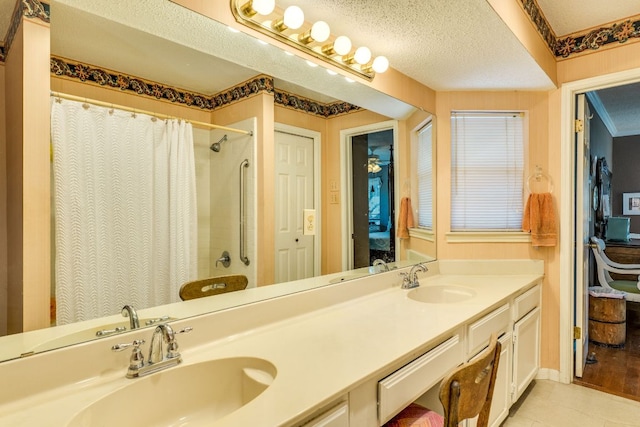 3508 Wendel Cv Unit H16, Austin, TX 78731 - bathroom featuring double vanity, a shower with shower curtain, tile patterned flooring, connected bathroom, and a textured ceiling