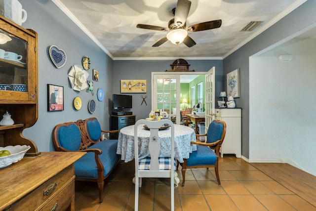 3508 Wendel Cv Unit H16, Austin, TX 78731 - dining room featuring a ceiling fan, tile patterned floors, and crown molding