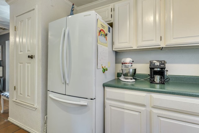 3508 Wendel Cv Unit H16, Austin, TX 78731 - kitchen with freestanding refrigerator, white cabinetry, and dark countertops
