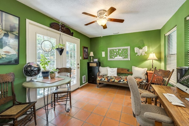 3508 Wendel Cv Unit H16, Austin, TX 78731 - dining area featuring a textured ceiling, a ceiling fan, and tile patterned floors