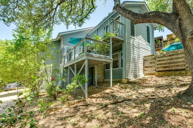 3508 Wendel Cv Unit H16, Austin, TX 78731 - rear view of property featuring a balcony and stone siding