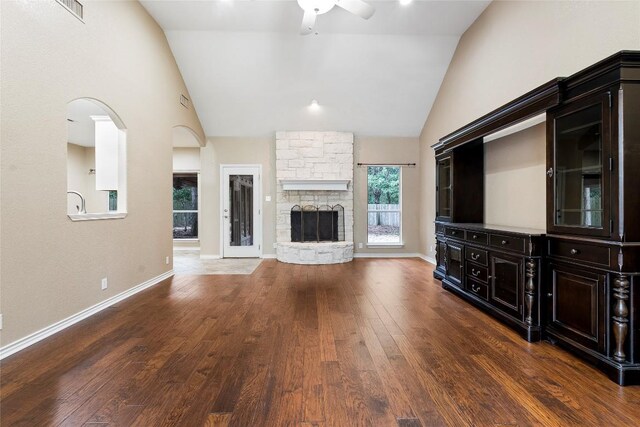 230 Cedar Hills Dr, Elgin, TX 78621 - unfurnished living room with a ceiling fan, high vaulted ceiling, hardwood / wood-style floors, a fireplace, and arched walkways