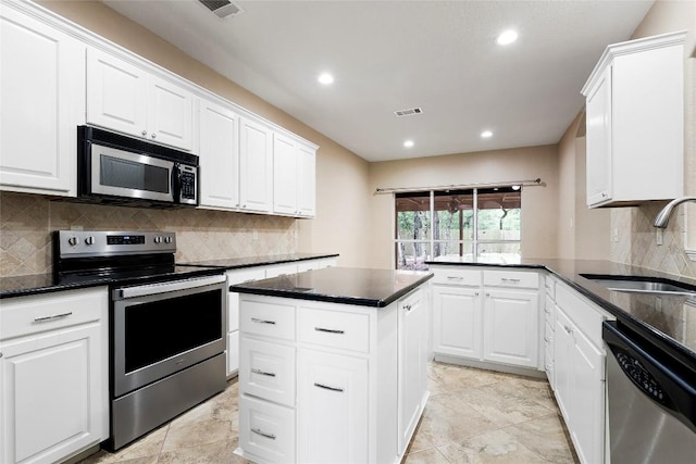 230 Cedar Hills Dr, Elgin, TX 78621 - kitchen featuring stainless steel appliances, white cabinets, backsplash, recessed lighting, and a peninsula