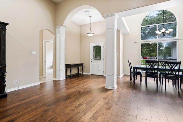 230 Cedar Hills Dr, Elgin, TX 78621 - dining space with arched walkways, a high ceiling, decorative columns, and wood finished floors