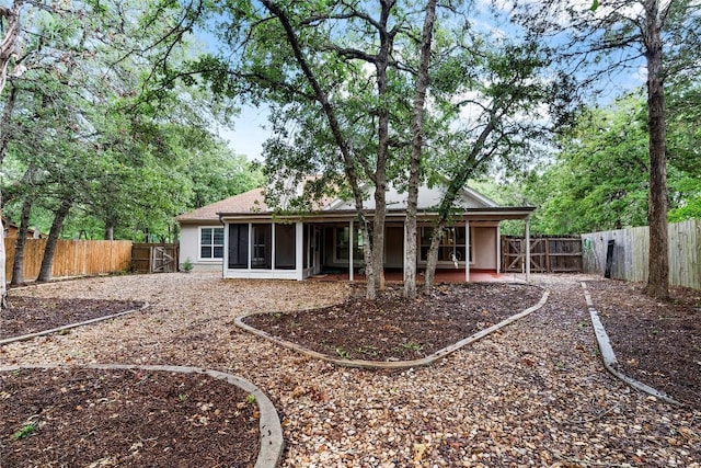 230 Cedar Hills Dr, Elgin, TX 78621 - rear view of house featuring a sunroom, stucco siding, and a fenced backyard