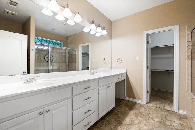 230 Cedar Hills Dr, Elgin, TX 78621 - bathroom featuring double vanity, a spacious closet, and a stall shower