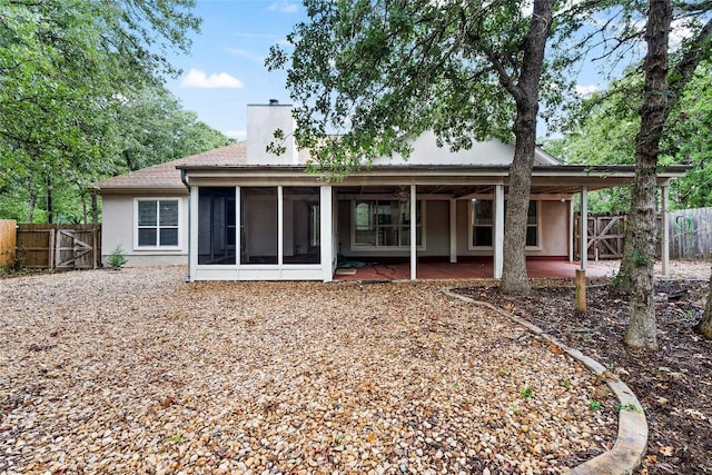 230 Cedar Hills Dr, Elgin, TX 78621 - back of property featuring a gate, a chimney, a sunroom, a fenced backyard, and a patio area