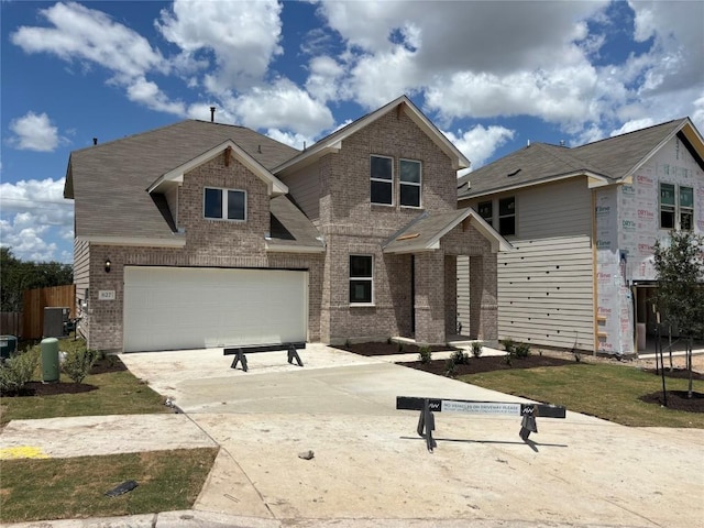 627 Palo Brea Loop, Hutto, TX 78634 - view of front facade featuring brick siding, concrete driveway, and a garage