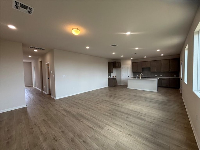627 Palo Brea Loop, Hutto, TX 78634 - unfurnished living room featuring light wood-style floors and recessed lighting