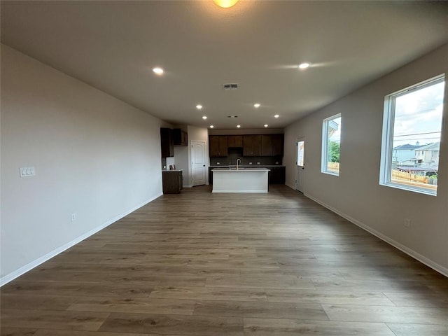 627 Palo Brea Loop, Hutto, TX 78634 - unfurnished living room with wood finished floors and recessed lighting