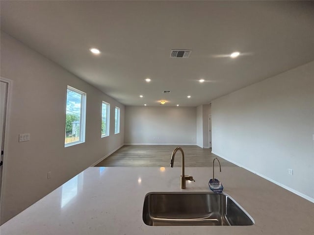627 Palo Brea Loop, Hutto, TX 78634 - kitchen with recessed lighting, open floor plan, and light stone counters